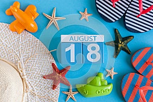 August 18th. Image of August 18 calendar with summer beach accessories and traveler outfit on background. Summer day