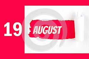 August 19th. Day 19 of month, Calendar date. Red Hole in the white paper with torn sides with calendar date. Summer month, day of