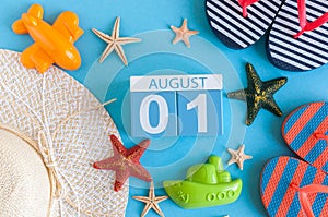 August 1st. Image of august 1 calendar with summer beach accessories and traveler outfit on background. Summer day