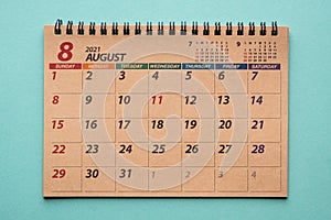 August 2021 desk calendar on green background