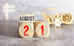 August 21st. Day 21 of month, daily calendar on white table with reflection, with light blue background
