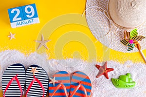 August 29th. Image of august 29 calendar with summer beach accessories and traveler outfit on background. Summer day