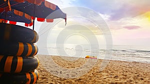 AUGUST 3, 2018: Life ring on the sand and umbrella on beach, Beautiful sea view background at Cha-am, Thailand