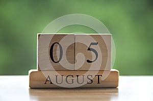 August 5 calendar date text on wooden blocks with blurred background park. Copy space and calendar concept