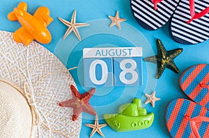 August 8th. Image of August 8 calendar with summer beach accessories and traveler outfit on background. Summer day