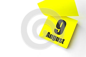 August 9th. Day 9 of month, Calendar date. Close-Up Blank Yellow paper reminder sticky note on White Background. Summer month, day