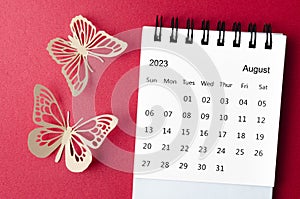 The August 2023 desk calendar for the organizer to plan and reminder with paer butterfly on red background