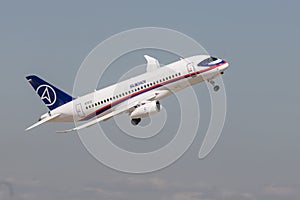 30 AUGUST 2019 MOSCOW, RUSSIA: A passenger plane flying in the overcast sky - SUKHOI SUPERJET100