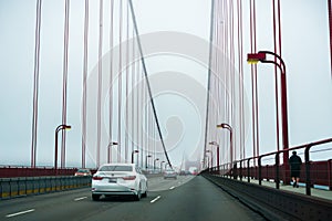 August 19, 2017, San Francisco/CA/USA - Driving on the Golden Gate bridge on a cold, foggy morning