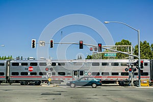 August 30, 2017 Sunnyvale/CA/USA - Caltrain crossing at a street junction near a residential neighborhood in south San Francisco