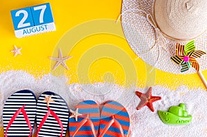 August 27th. Image of august 27 calendar with summer beach accessories and traveler outfit on background. Summer day photo