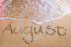 August written on beach