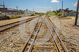 Railroad tracks through an industrial area center view