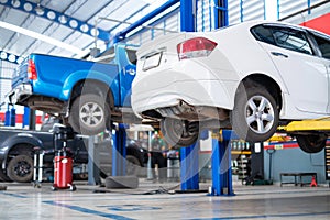 Auomobile repair, Car service centre auto repair with wehicle raised on lift workshop. Car repair service center