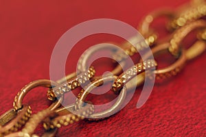 Aureate chain close-up on a red background photo