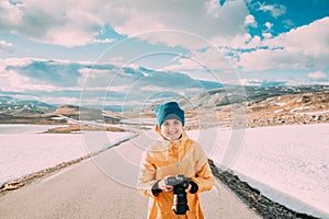 Aurlandsfjellet, Norway. Young Happy Woman Tourist Traveler Photographer Taking Pictures Photos Of Aurlandsfjellet
