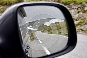 The Aurlandsfjellet (Snow Road) reflected in a car mirror. Norway.