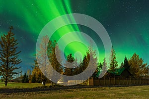 Aurora Borealis in an amazing nightscape. Travel destination with beautiful green lights landscape.