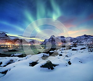 Aurora borealis on the Lofoten islands, Norway. Green northern lights above mountains.