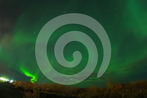 Aurora borealis in night northern sky. Ionization of air particl