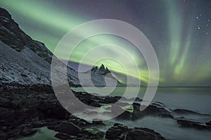 Aurora Borealis Northern Lights above Mountains in Iceland