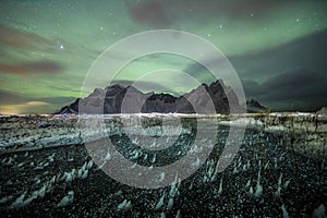 Aurora Borealis Northern Lights above Stokksnes Beach and Vestrahorn Mountains, Iceland