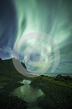 Aurora Borealis Northern Lights above Stokksnes Beach and Vestrahorn Mountains, Iceland