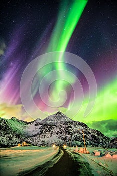 Aurora Borealis (Northern lights) explosion over mountains and r