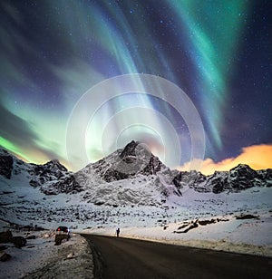 Aurora Borealis (Northern lights) explosion over snow mountain