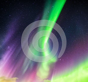 Aurora Borealis or Northern lights green and purple colors with starry in night sky