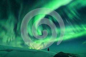 Aurora borealis and silhouette of a man on the hill