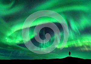 Aurora borealis and silhouette of standing man