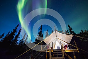 Aurora over canvas tent in Alaska