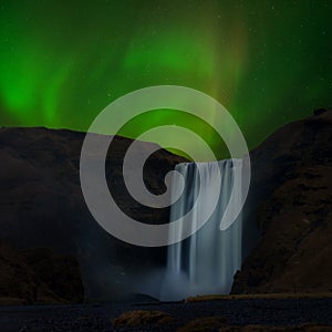 The aurora over Skogafoss of Iceland