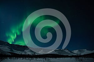 Aurora polaris above mountains photo