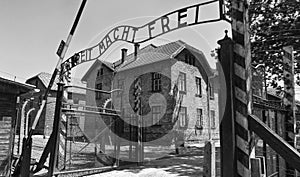 Auschwitz Concentration Gate, ARBEIT MACHT FREI sign. Sunny day on the July 7th, 2015. Black and white. Krakow, Poland