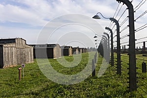Auschwitz II -Birkenau Extermination camp barbed wire fence and wooden housing