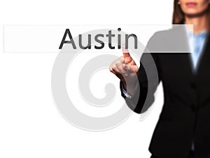 Austin - Businesswoman hand pressing button on touch screen interface.