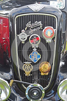 Austin Seven radiator grill with motoring badges.