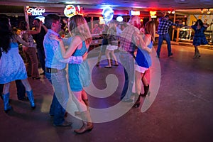 People dancing country music in the Broken Spoke dance hall in Austin, Texas