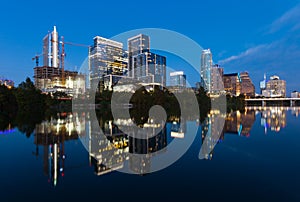 Austin, Texas with new buildings rising, reflecting in Lady Bird Lake during sunset / Austin Skyline and new constructions