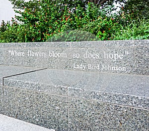 AUSTIN TEXAS- SEPTEMBER 17, 2017:Quote: `Where flowers bloom so does hope` by Lady Bird Johnson on a bench outside The Lyndon B