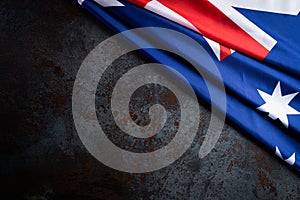 Australia day concept. Australian flag with the text Happy Australia day against a black stone texture background. 26 January