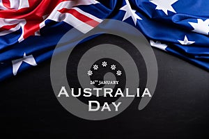 Australia day concept. Australian flag with the text Happy Australia day against a blackboard background. 26 January