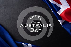 Australia day concept. Australian flag with the text Happy Australia day against a blackboard background. 26 January