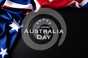 Australia day concept. Australian flag with the text Happy Australia day against a blackboard background. 26 January