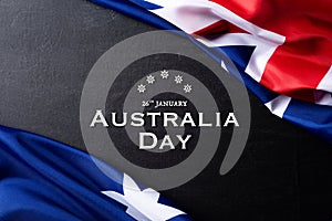 Australia day concept. Australian flag with the text Happy Australia day against a blackboard background. 26 January