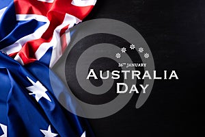 Australia day concept. Australian flag with the text Happy Australia day against a blackboard background. 26 January