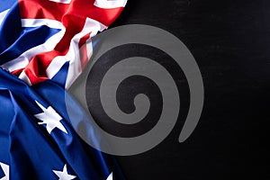 Australia day concept. Australian flag with the text Happy Australia day against a blackboard background. 26 January