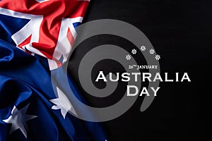 Australia day concept. Australian flag with the text Happy Australia day against a blackboard background. 26 January